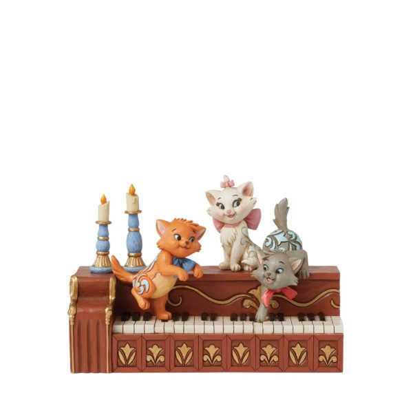 Pattes en jeu (Figurine de chatons des Aristochats sur piano)